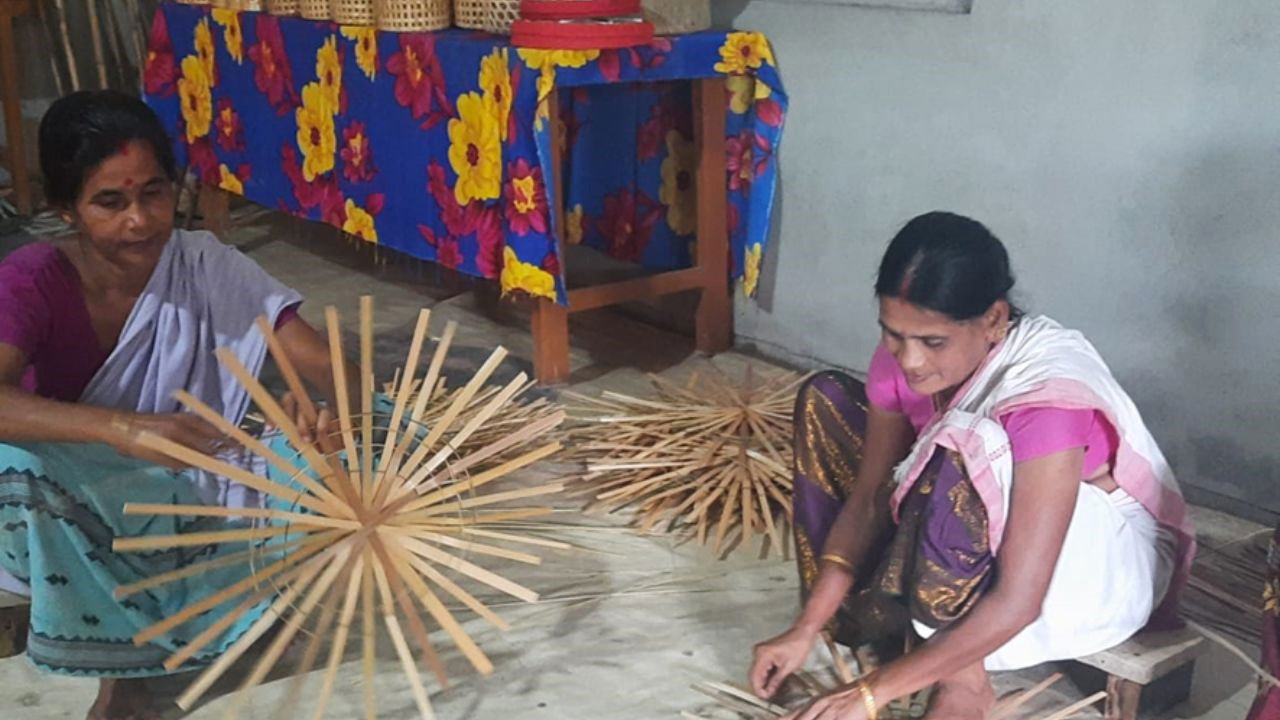 Female artisans weaving bamboo into intricate baskets and other products