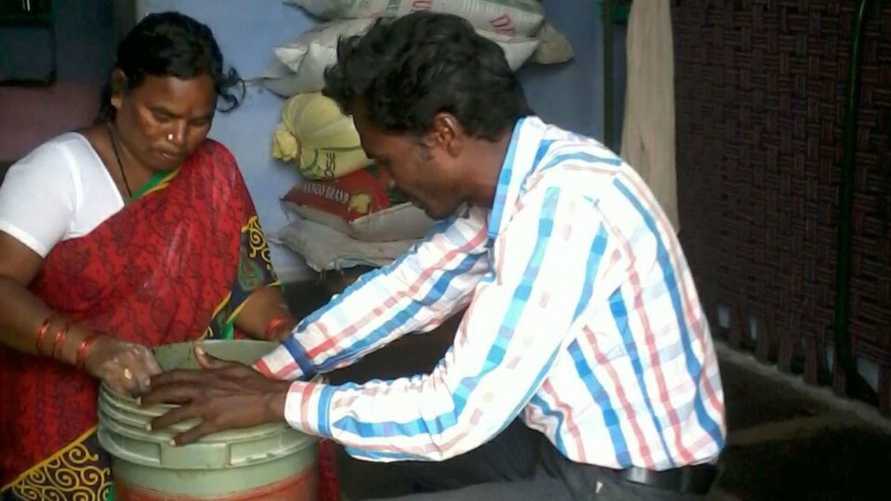 B. Naidu preparing a nutrient-rich fertilizer solution