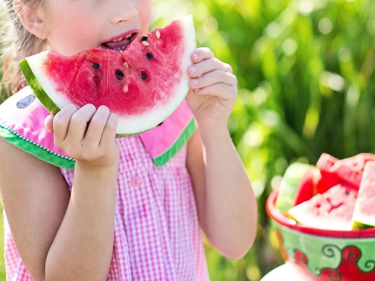Child relishing a piece of watermelon