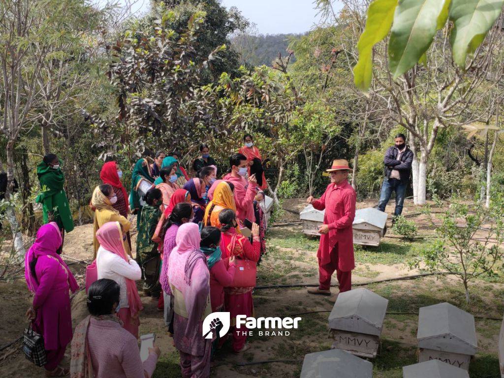 Col. P.C. Rana demonstrating beekeeping in his farm