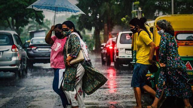 people crossing road in rainfall