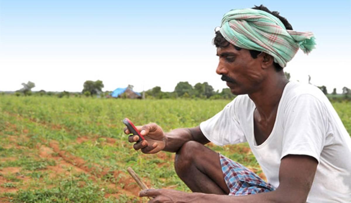 Farmer with his Phone in field