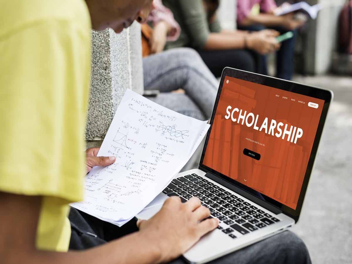 Student with his laptop filling scholarship form