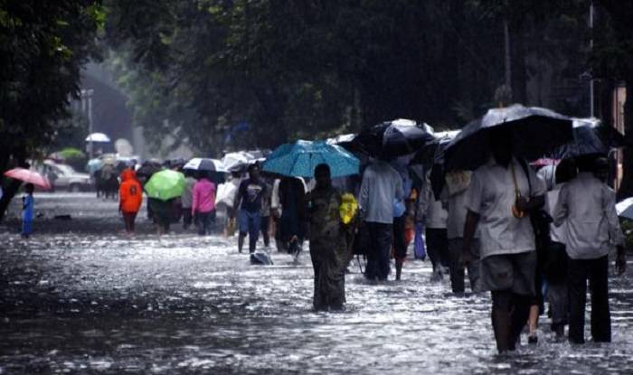 People walking on road in rainfall