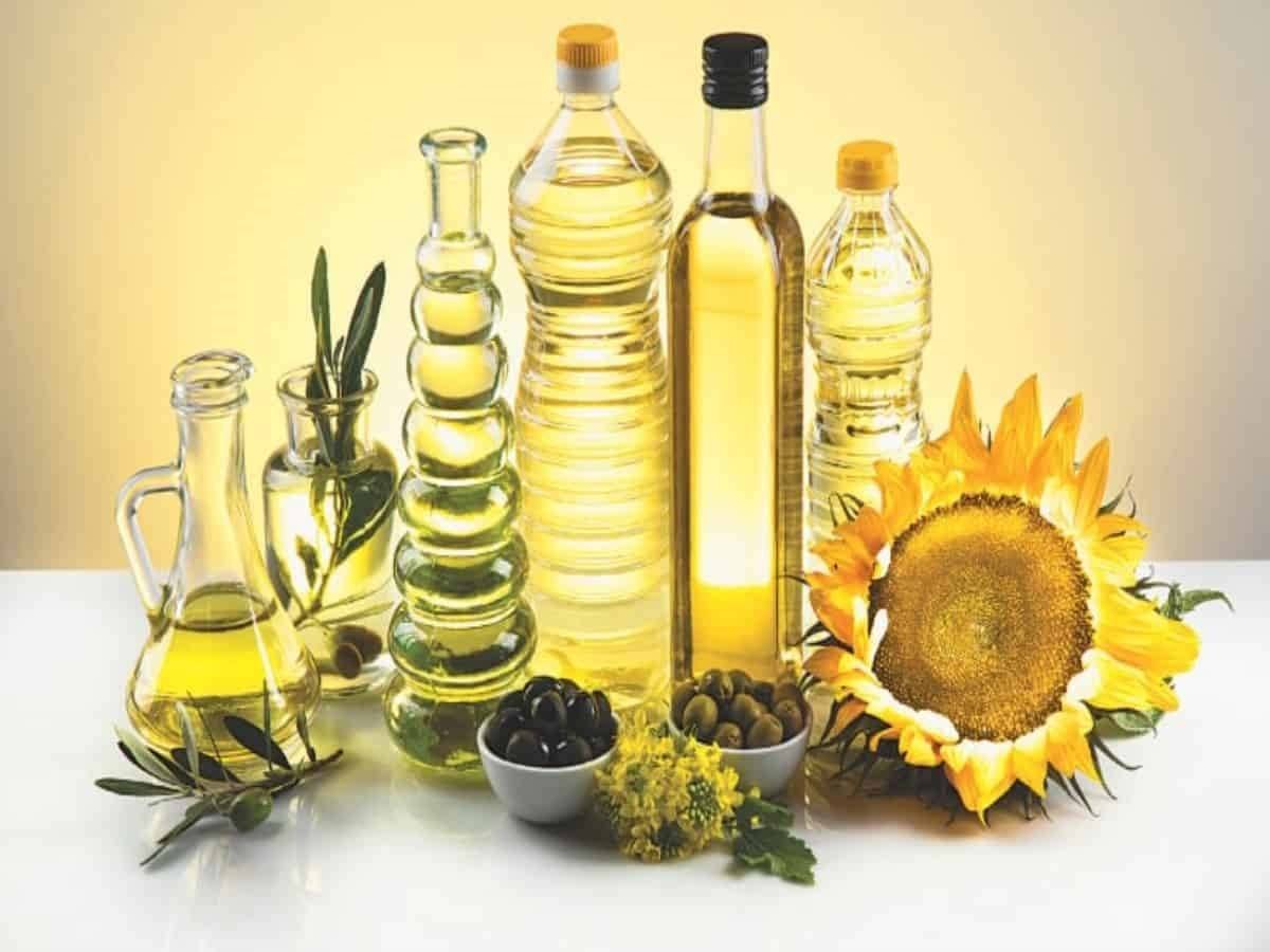 Different types of edible oil on table