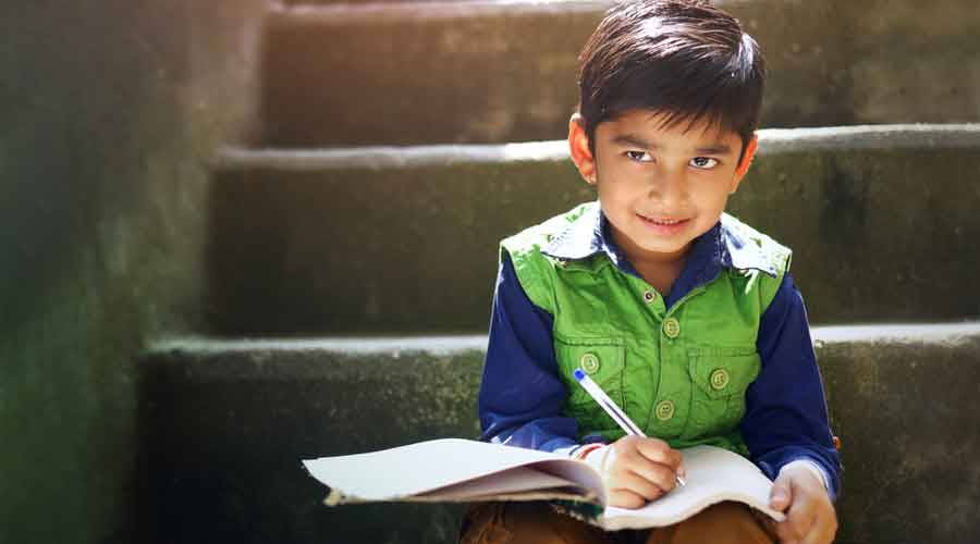 A Child Engaged In His Studies