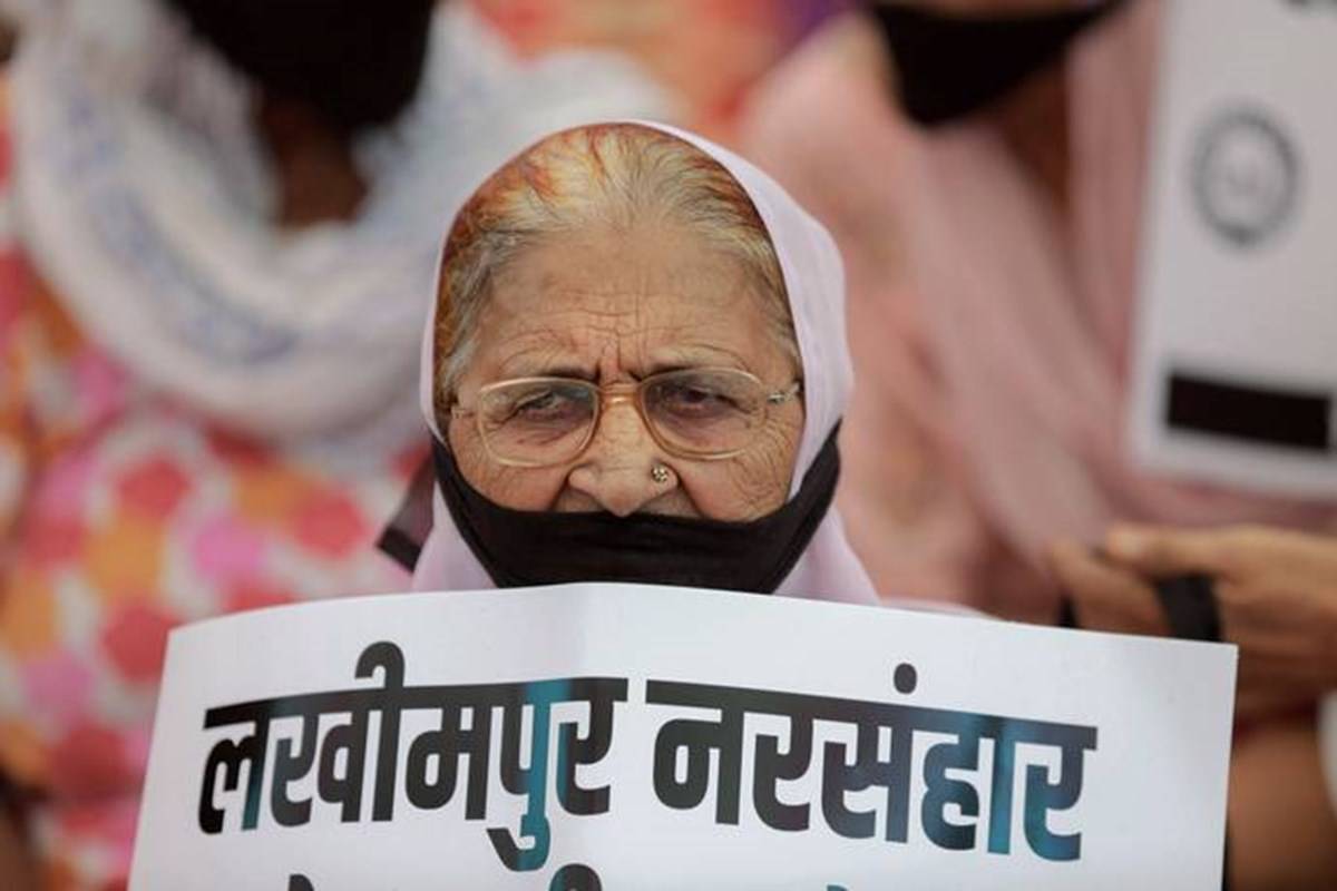Old Lady with a poster in hand observing Shaheed Kisan Diwas
