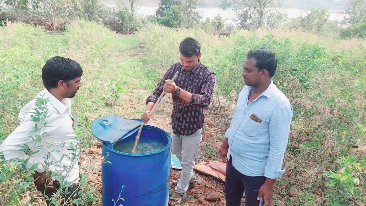 AEO Santosh explaining waste decomposer preparation to farmers