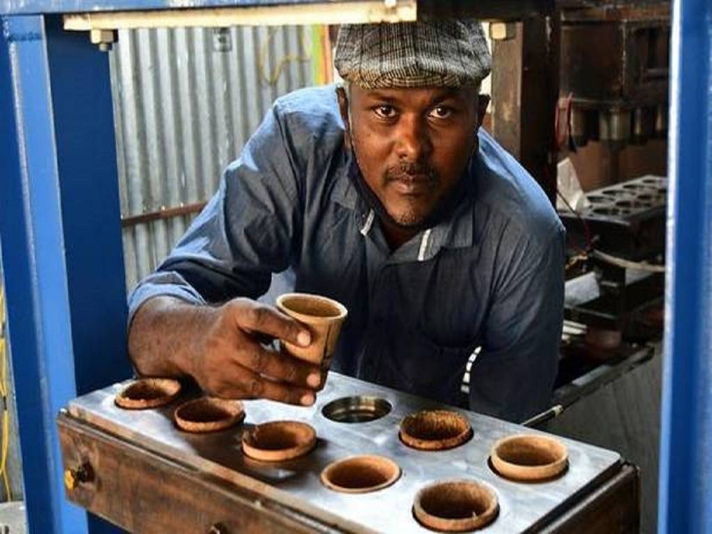 Man demonstrating teacups made up of Rice Bran