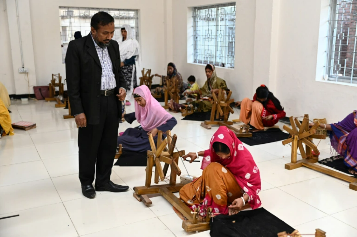 Ayub Ali Looks on as workers spin thread from cotton to make traditional muslin garments at the Dhakai Muslin Project facility in Narayanganj, Bangladesh