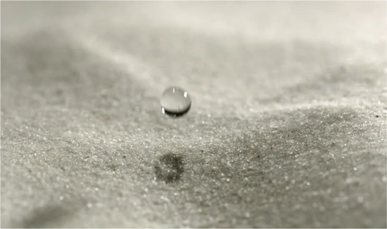 Falling water drop on sand