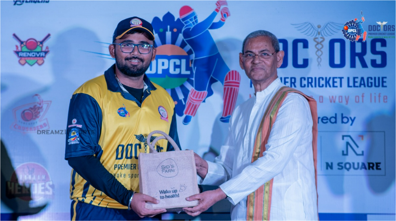 A doctor cricketer while receiving a gift pack of Sid's Farm Dairy products during the award ceremony of the Doctors Premier Cricket League