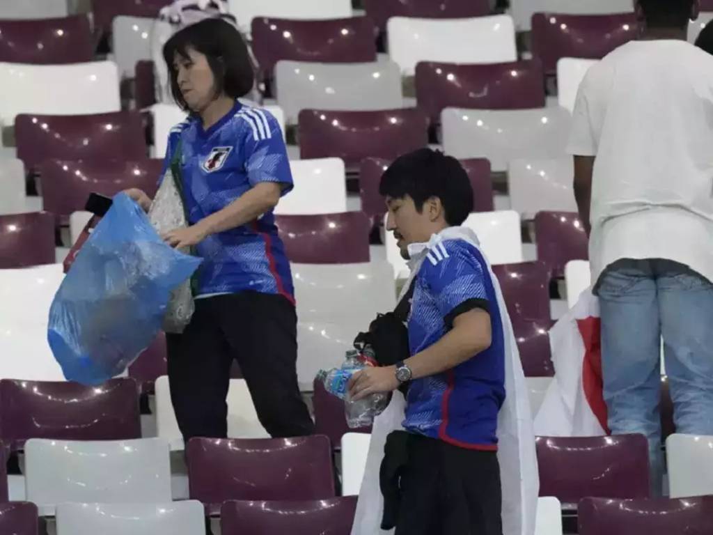 Japan Nationals Picks Up Litter at Qatar Stadium