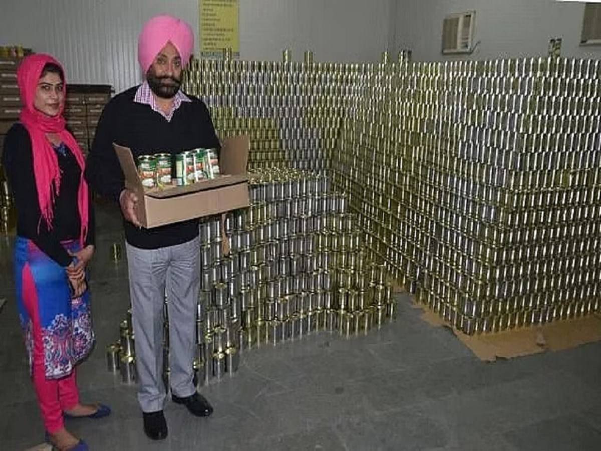 Jagmohan Singh Nagi with his canned goods that he sells to Multinational companies.