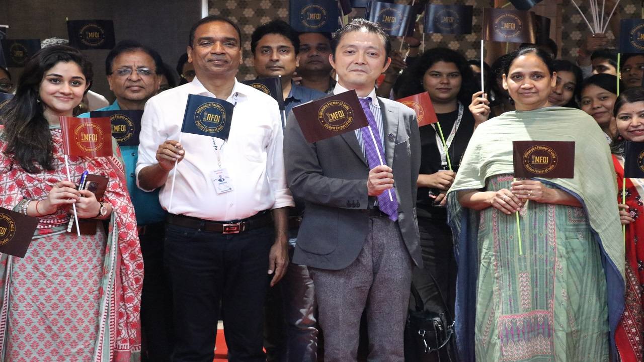 Japan International Cooperation Agency India Head Saito Mitsunori holding MFOI's flag in the centre