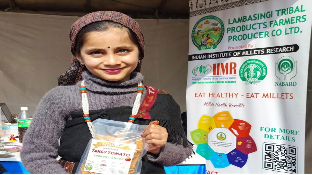 A customer buying Tangy Tomato 'Millet Healthy Bites' at NABARD Agri Expo 2023